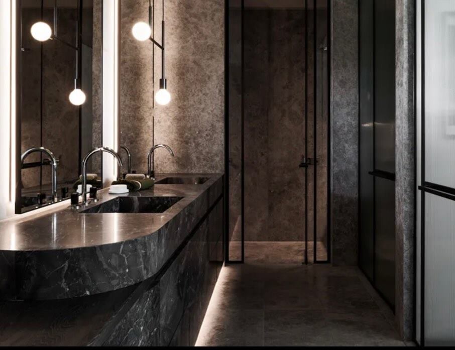 Butler&rsquo;s pantry in dark veined stone with pendant lights and integrated joinery.